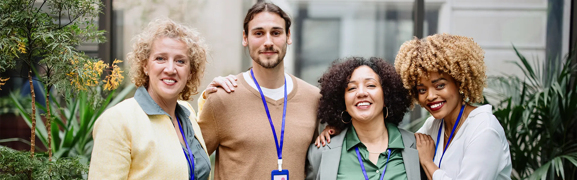 Four people with arms around each other smiling for the camera