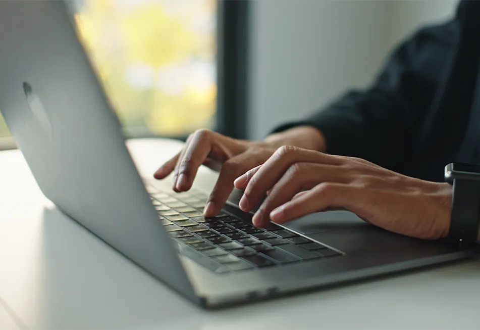 Person typing on a laptop keyboard