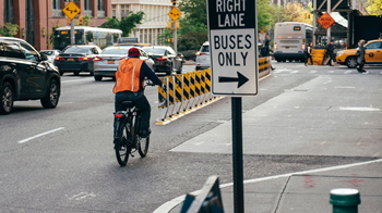 Man riding a bike in a bike lane on a road