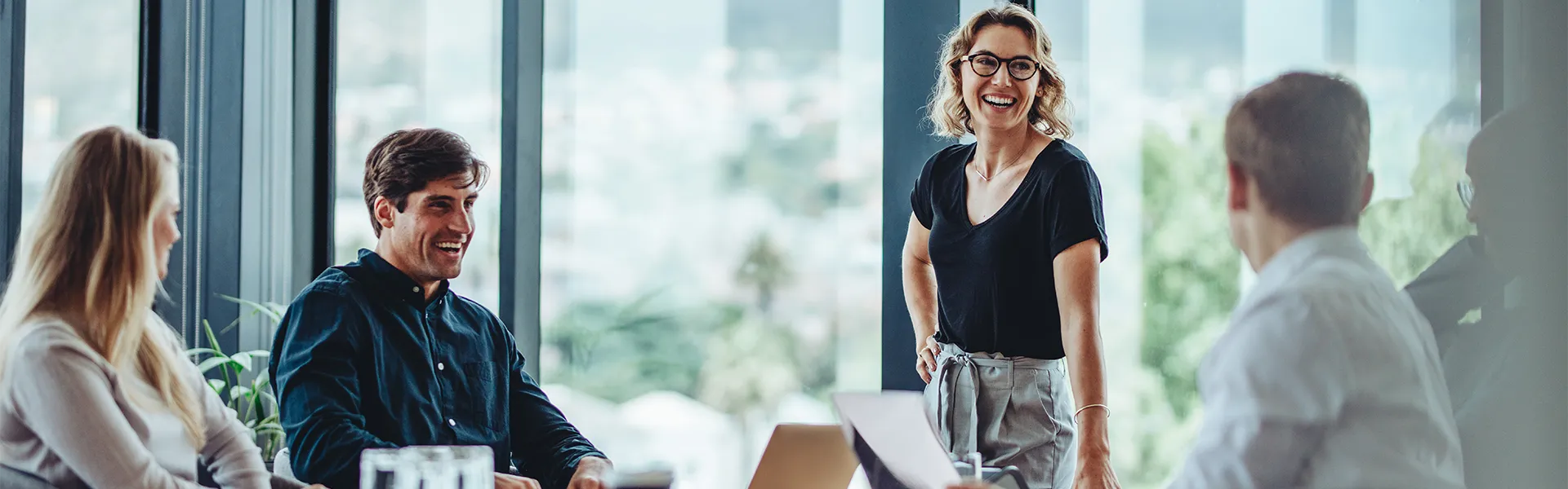 Happy lady giving a presentation at a meeting