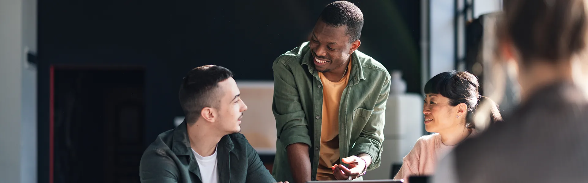 A group of individuals having a discussion around a table