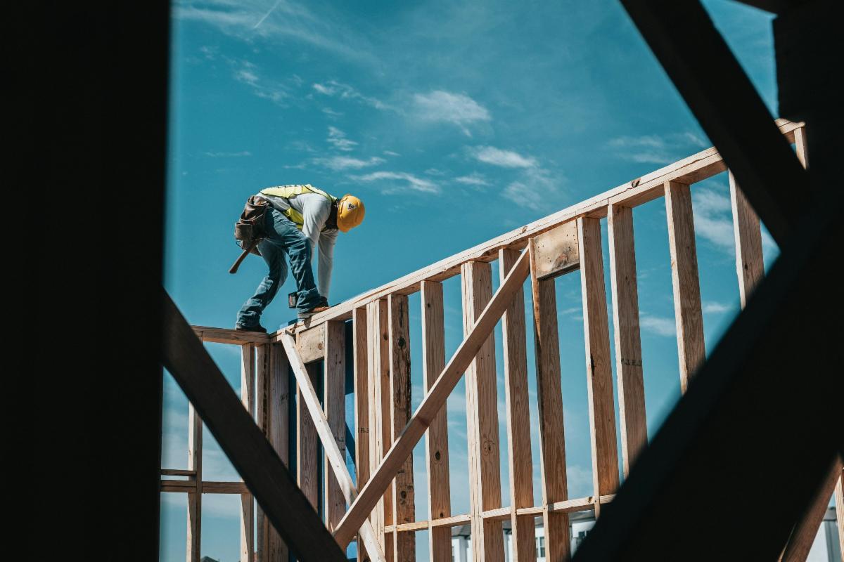 Man standing on a wall of a house being built